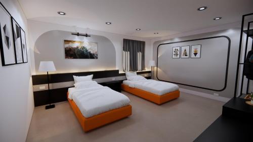 a bedroom with two beds and two lamps in it at TC Garden Resort in Kuah