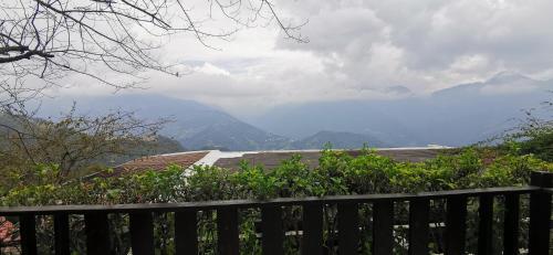 a fence with a view of a mountain at Villa Relax in Renai