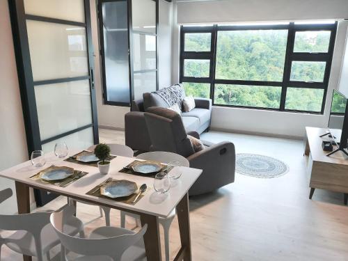 a living room with a table with wine glasses on it at City View with Jesselton Quay Near Suria Sabah Mall & Jesselton Point in Kota Kinabalu