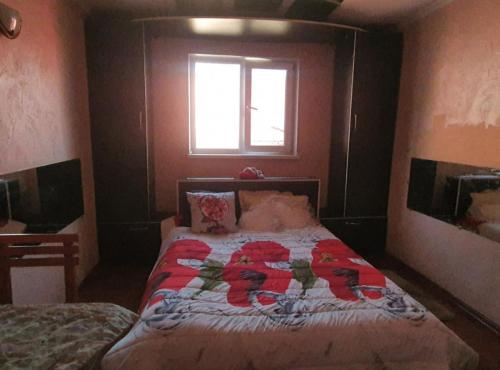 a bedroom with a bed with a quilt on it at Diana center Hotel with Grill zone and yard in Chişinău