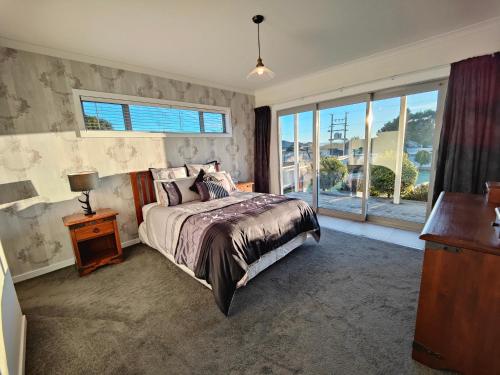 a bedroom with a bed and a large window at Church Street Charmer in Riverton
