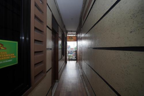 a long hallway with a sign on the wall at Hotel Soreang in Bandung