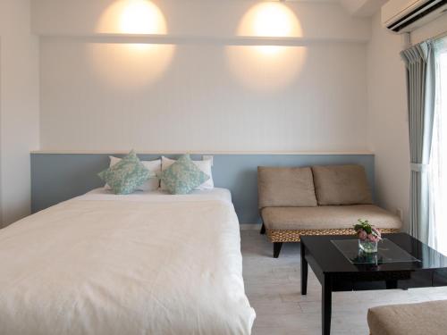 Ένα ή περισσότερα κρεβάτια σε δωμάτιο στο Cozy Stay in Naha
