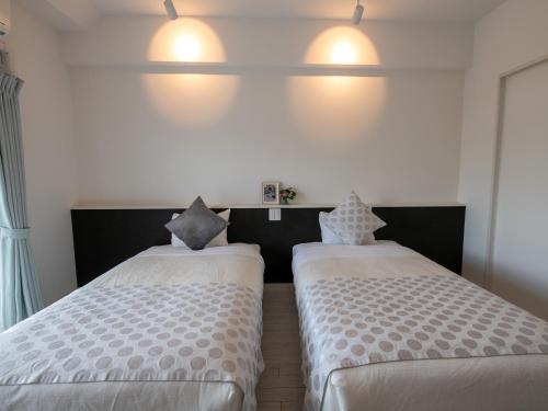 Ένα ή περισσότερα κρεβάτια σε δωμάτιο στο Cozy Stay in Naha