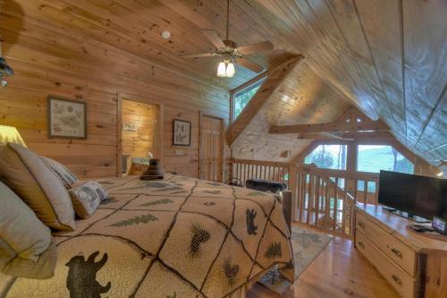 a bedroom with a bed in a log cabin at Wind Rush in Ellijay