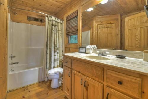 a bathroom with a sink and a toilet and a tub at Lakeview Escape in Ellijay