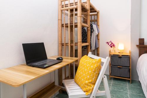 a laptop computer sitting on a desk in a room at Garden Home 1 in Haad Yao