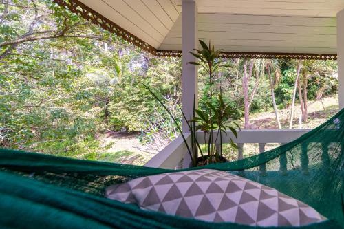 a hammock on the porch of a house at Garden Home 1 in Haad Yao