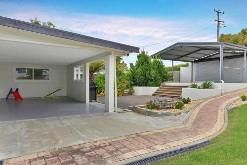 a house with a patio and a garage at The BEST Scamander Beach House! in Scamander