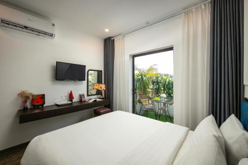a hotel room with a bed and a balcony at Dream Central Hotel in Hanoi