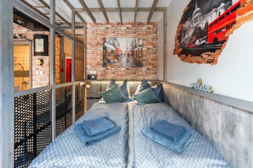 a bed on a balcony with two pillows on it at Olivia apartament przy deptaku in Szczawno-Zdrój