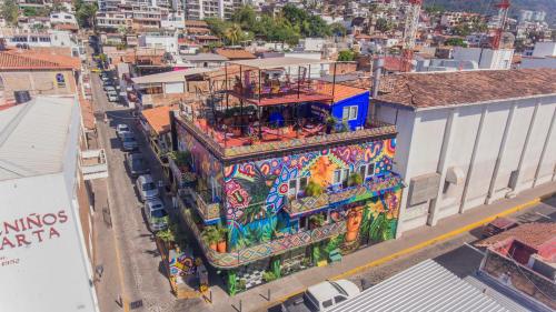 an apartment building with a mural on the side of it at Casa Colibrí Malecón in Puerto Vallarta