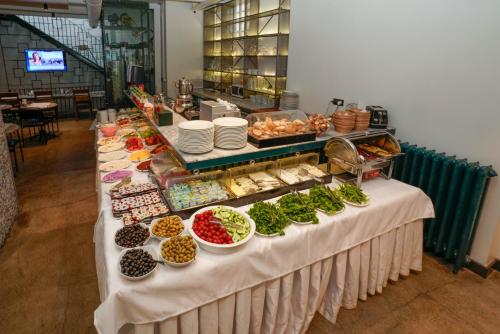 Una mesa de buffet con muchos tipos diferentes de comida. en Faros Hotel Taksim-Special Category, en Estambul