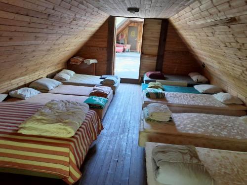 a bunch of beds lined up in a room at Annimatsi Camping in Otepää