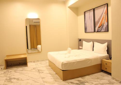 Ixoras Hotel Lembaにあるベッド