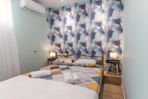 a bedroom with a bed with towels on it at La Petit Maison in Thessaloniki