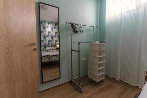 a bathroom with a glass shower with a mirror at La Petit Maison in Thessaloniki