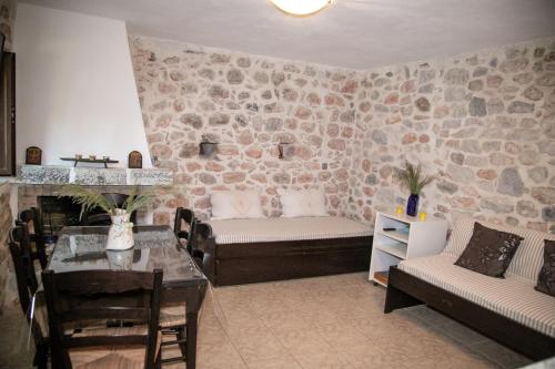 a living room with a couch and a table at Anna's Garden in Triandafilliá