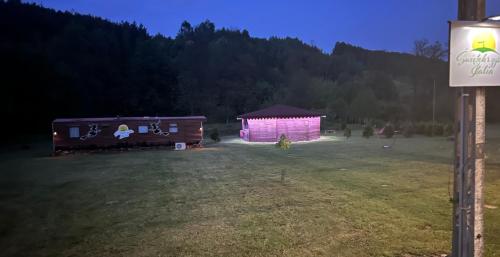 a purple shed in a field at night at Świętokrzyska Italia in Włochy
