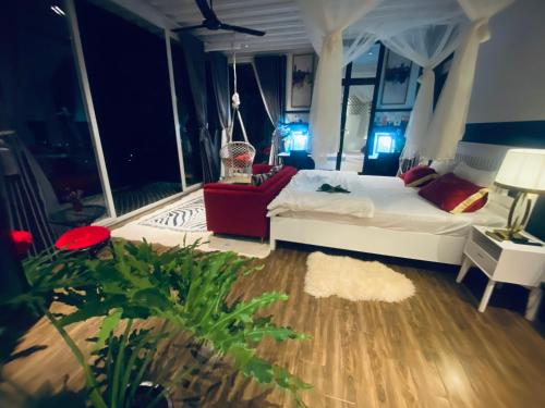 a bedroom with a bed and a chair in a room at Nacasoo hill in Tiên Hai