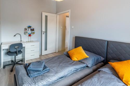 ein Wohnzimmer mit einem Sofa und einem Schreibtisch in der Unterkunft Emerald Apartament przy deptaku in Bad Salzbrunn