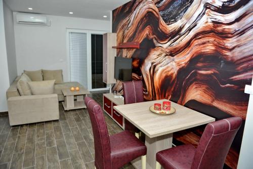 a living room with a table and chairs and a couch at Velestovo House in Ohrid