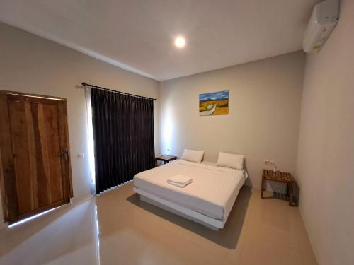A bed or beds in a room at Village Corner Homestay