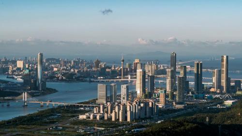 an aerial view of a large city with a bridge at Pullman Zhuhai in Zhuhai