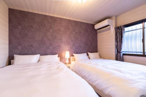 Una cama o camas en una habitación de ルグランみしま