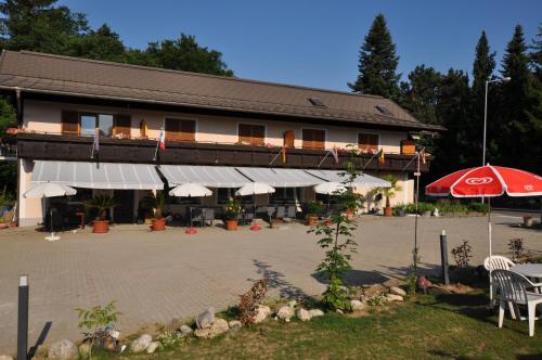 a large building with a patio and an umbrella at Kärnten Appartements in Velden am Wörthersee