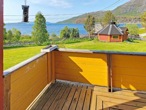 a wooden balcony with a view of the water at 6 person holiday home in Kviby in Kviby