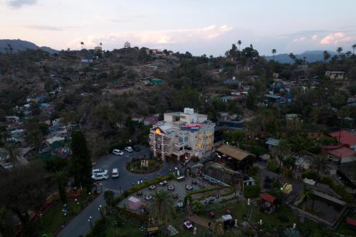 an overhead view of a city with a building at Chacha Inn The Garden Retreat in Mount Ābu