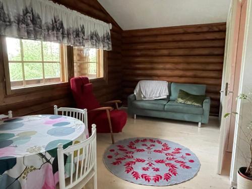 a living room with a couch and a table at Mökki Ruohola in Taivalkoski