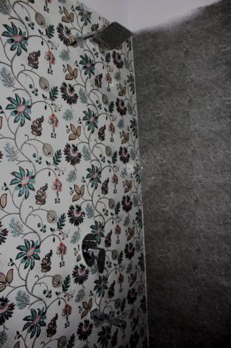 a curtain with a floral pattern on a wall at Friend India in Jaipur
