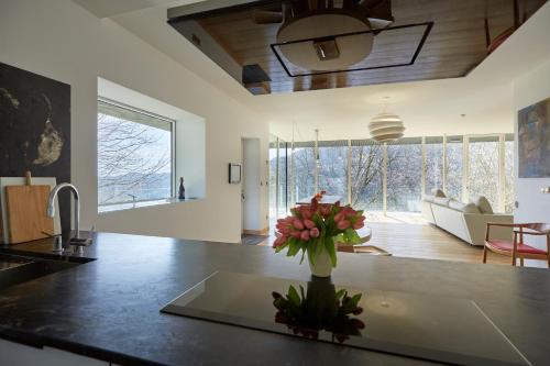 a kitchen with a vase of flowers on a counter at Apartamentos Ea Astei in Ea