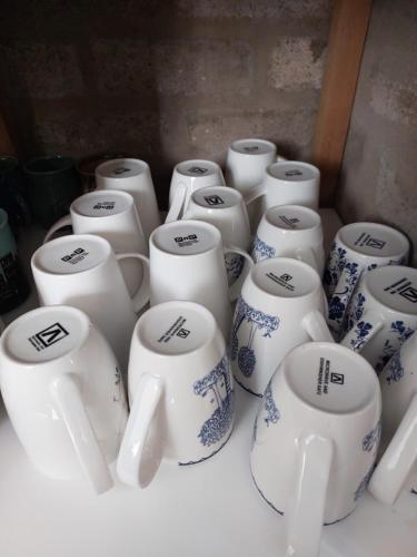 a group of white and blue cups sitting on a table at Lieflappie❤ in Stilbaai