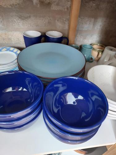 a group of blue plates and bowls on a table at Lieflappie❤ in Stilbaai