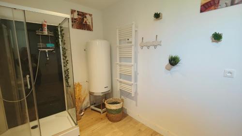 a bathroom with a walk in shower and a water heater at Entre terres et mer chez Carméla in Bazinghen