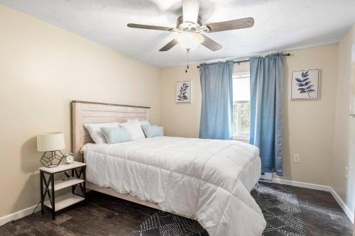 a bedroom with a bed and a ceiling fan at Hot Tub! LRG Home! Sleeps 24!Near Ithaca! Dogs OK in Lansing