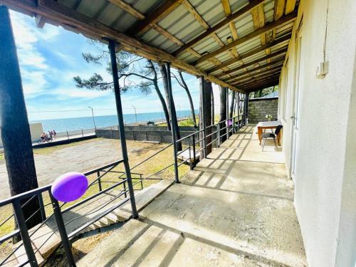 a balcony of a house with a view of the beach at Guesthouse ''Loni'' in Ureki