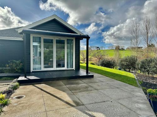 a screened in porch on a house at Lifestyle Guesthouse in Dairy Flat