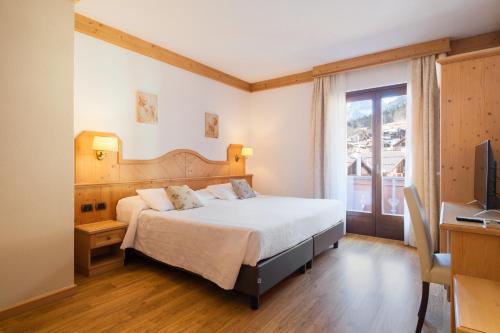 Posteľ alebo postele v izbe v ubytovaní Il Piccolo Dolomiti Resort
