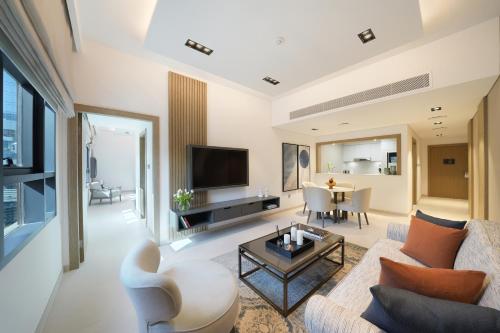 a living room with a couch and a table at Cheval Maison - The Palm in Dubai