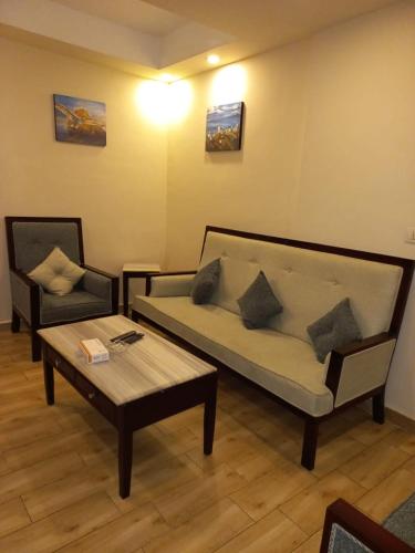 a living room with a couch and a coffee table at Jewel San Stefano Hotel in Alexandria