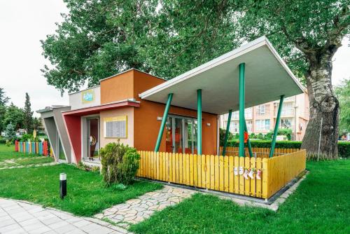 a small building with a fence in front of it at AluaSun Helios Beach - All Inclusive in Obzor