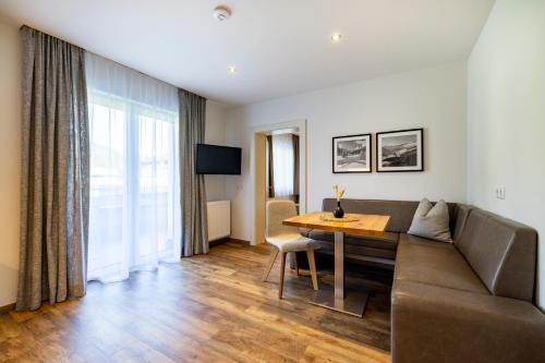 a living room with a couch and a table at Aparthotel Jägerheim in Flachau