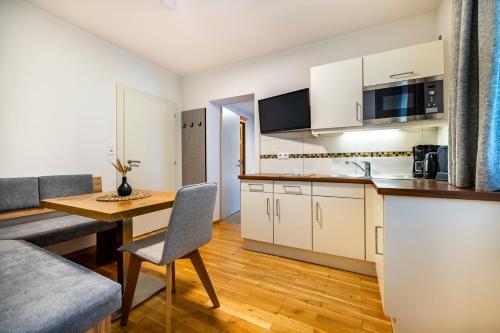a kitchen with a table and a dining room at Aparthotel Jägerheim in Flachau