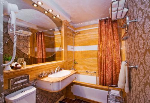 a bathroom with a sink and a mirror at Imperial Hotel & Restaurant in Vilnius