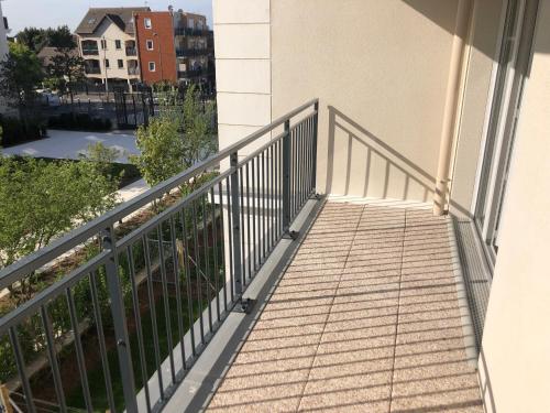 a balcony of a building with a railing at BEAU STUDIO NEUF AVEC TERRASSE in Le Blanc-Mesnil