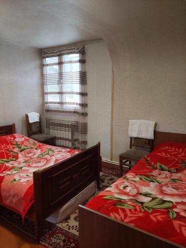 a bedroom with two beds and a window at Arman Guest House in Dilijan